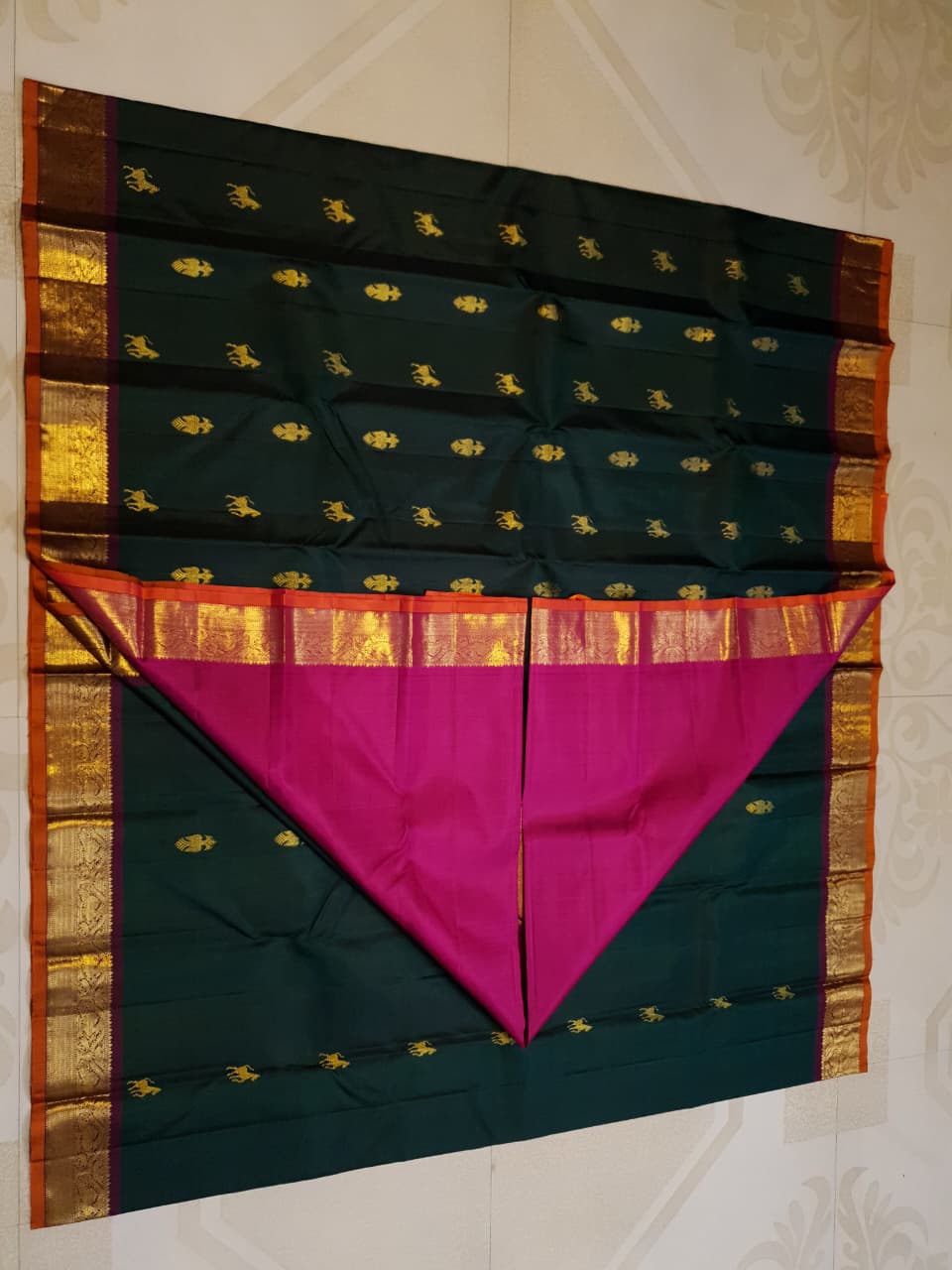 Bottle Green Kanjivaram Silk Saree with  Pink Zari Border.